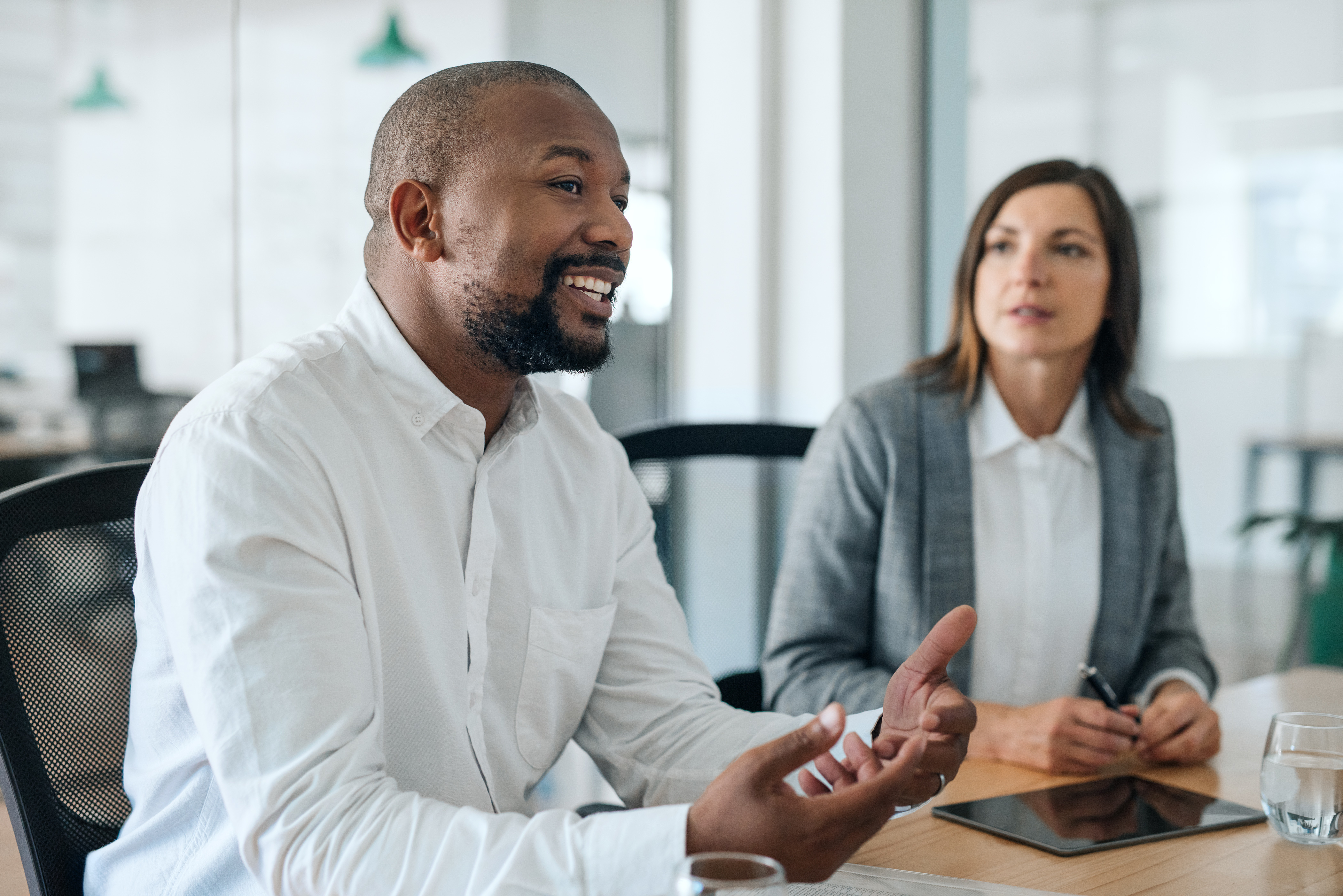 HR professionals sit in an office together